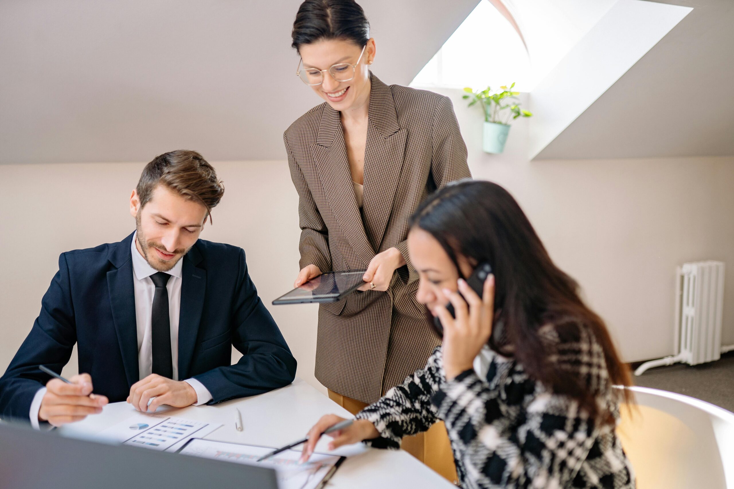 A team gathered in a conference room discussing direct marketing campaigns.